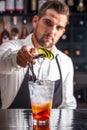 Barman decorating cocktail