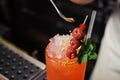 Barman is decorating cocktail with rasberry Royalty Free Stock Photo