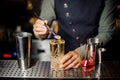 Barman decorating a sweet alcoholic cocktail with a flower