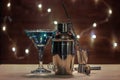 Barman equipment for making a cocktail on the background of wooden boards with natural blur of the garland. Royalty Free Stock Photo
