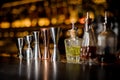 Barman equipment such as measuring cups and essence on the bar counter