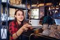 The barman girl works at bar in restaurant