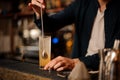 Barman hand stirring a fresh and sweet orange summer cocktail Royalty Free Stock Photo