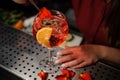 Barman hands decorating a glass of Aperol syringe cocktail with Royalty Free Stock Photo