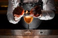 Barman hands making a fresh alcoholic drink with a smoky note Royalty Free Stock Photo