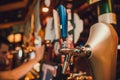 Barman hands pouring a lager beer in a glass. Royalty Free Stock Photo