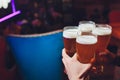 Barman hands pouring a lager beer in a glass. Royalty Free Stock Photo