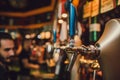 Barman hands pouring a lager beer in a glass. Royalty Free Stock Photo