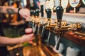 Barman hands pouring a lager beer in a glass. Royalty Free Stock Photo