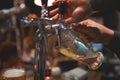 The barman with the help of a tap pours a mug of cold and refreshing light beer Royalty Free Stock Photo