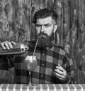 Barman or hipster pouring glass, makes fresh drink with ice