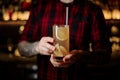 Barman holding a glass of fresh alcoholic orange cocktail Royalty Free Stock Photo
