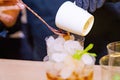 Barman making a coffee cocktail and a mojito