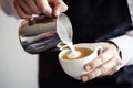 Barman making coffee, pouring milk