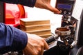 Closeup of barmen hand brewing espresso in professional coffee machine