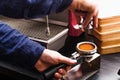 Closeup of barmen hand brewing espresso in professional coffee machine