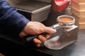 Closeup of barmen hand brewing espresso in professional coffee machine