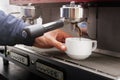 Closeup of barmen hand brewing espresso in professional coffee machine