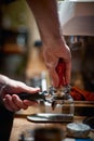 A barman is making an espresso coffee behind the bar. Coffee, beverage, bar Royalty Free Stock Photo