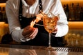 Barman making a fresh burning cocktail with fire