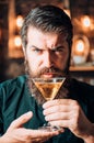 Barman with martini or liquor. Bearded man wearing suit and drinking alcohol. Drink and celebration party concept Royalty Free Stock Photo