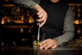 Barman mixing a cane sugar with lime Royalty Free Stock Photo