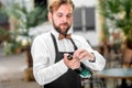 Barman opening bottle with sparkling wine Royalty Free Stock Photo