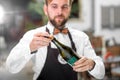 Barman opening bottle with sparkling wine Royalty Free Stock Photo