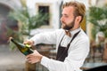 Barman opening bottle with sparkling wine Royalty Free Stock Photo