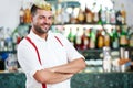 Barman portrait standing near bartender desk in restaurant bar