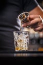 Barman is pouring alcohol from a jigger Royalty Free Stock Photo