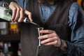 Barman pouring alcohol in the jigger. Royalty Free Stock Photo