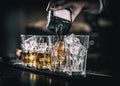 Barman pouring alcoholic drink