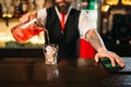 Barman pouring alcoholic drink in glass Royalty Free Stock Photo