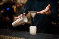 Barman pouring an alcoholic milkshake into a cocktail glass Royalty Free Stock Photo