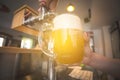 Barman pouring beer into glass in restaurant, pub, bar