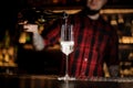 Barman pouring champagne into an elegant glass