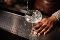 Barman pouring into champagne glass and making a splash