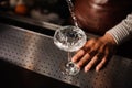 Barman pouring into champagne glass and making a splash