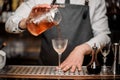 Barman pouring fresh alcoholic drink into the cocktail glass Royalty Free Stock Photo