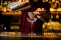 Barman pouring fresh alcoholic drink into an elegant glass Royalty Free Stock Photo