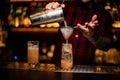 Barman pouring fresh lemonade cocktail into a glass Royalty Free Stock Photo