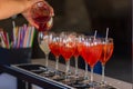 Barman pouring a fresh pink alcoholic cocktail into the elegant glass on the bar counter Royalty Free Stock Photo