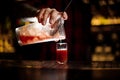 Barman pouring alcoholic tomato cocktail into a glass shot Royalty Free Stock Photo