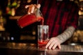 Barman pouring fresh salty tomato alcoholic drink into a glass Royalty Free Stock Photo