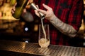 Barman pouring a portion of alcoholic drink using jigger Royalty Free Stock Photo