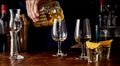 Barman pouring spirits from a cut glass decanter