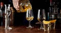 Barman pouring spirits from a cut glass decanter