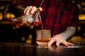 Barman pouring strong alcoholic cocktail of whiskey Royalty Free Stock Photo