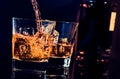 Barman pouring whiskey in front of whiskey glass and bottle Royalty Free Stock Photo